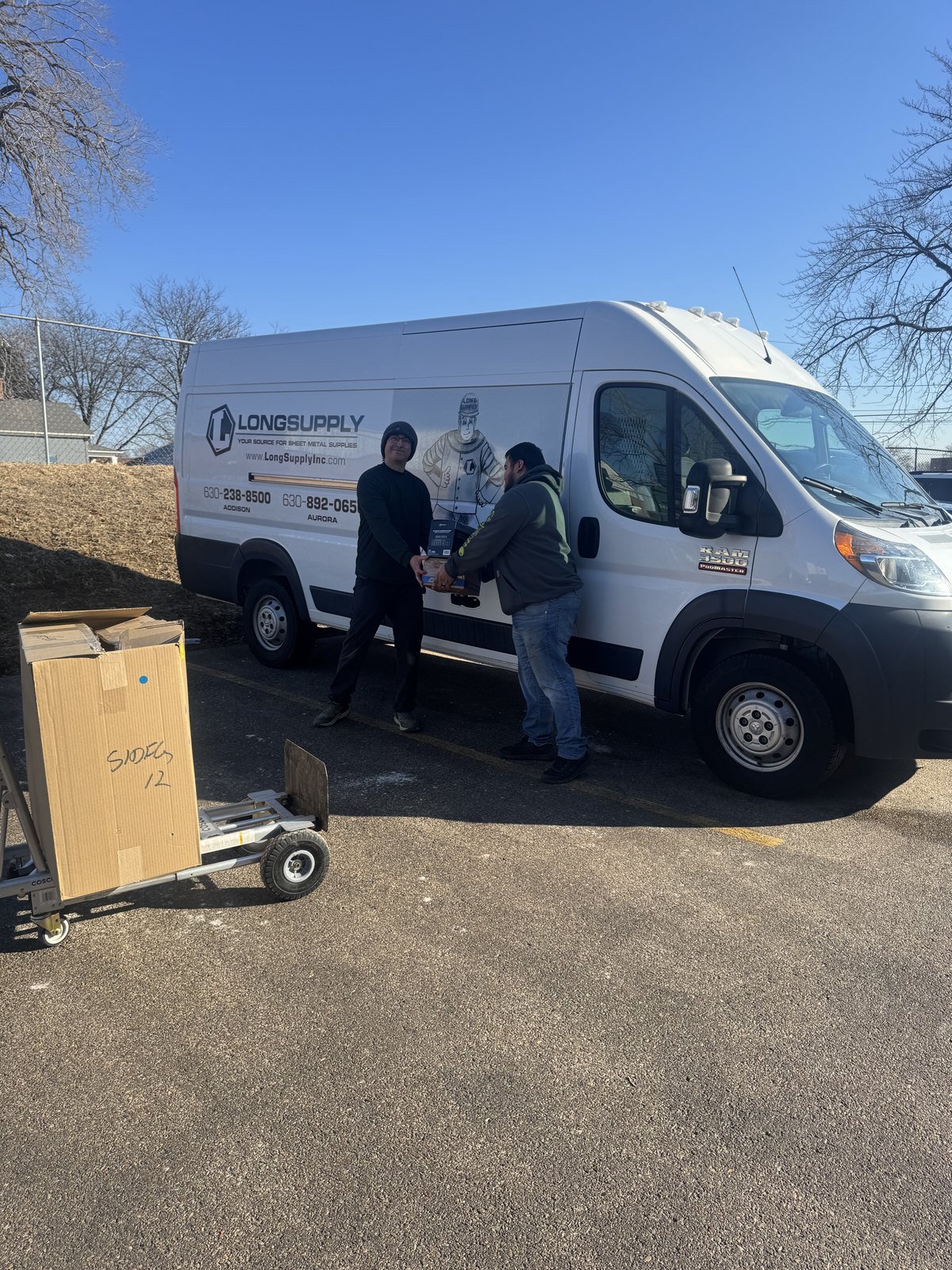 Long Supply delivery team loading materials for a jobsite delivery